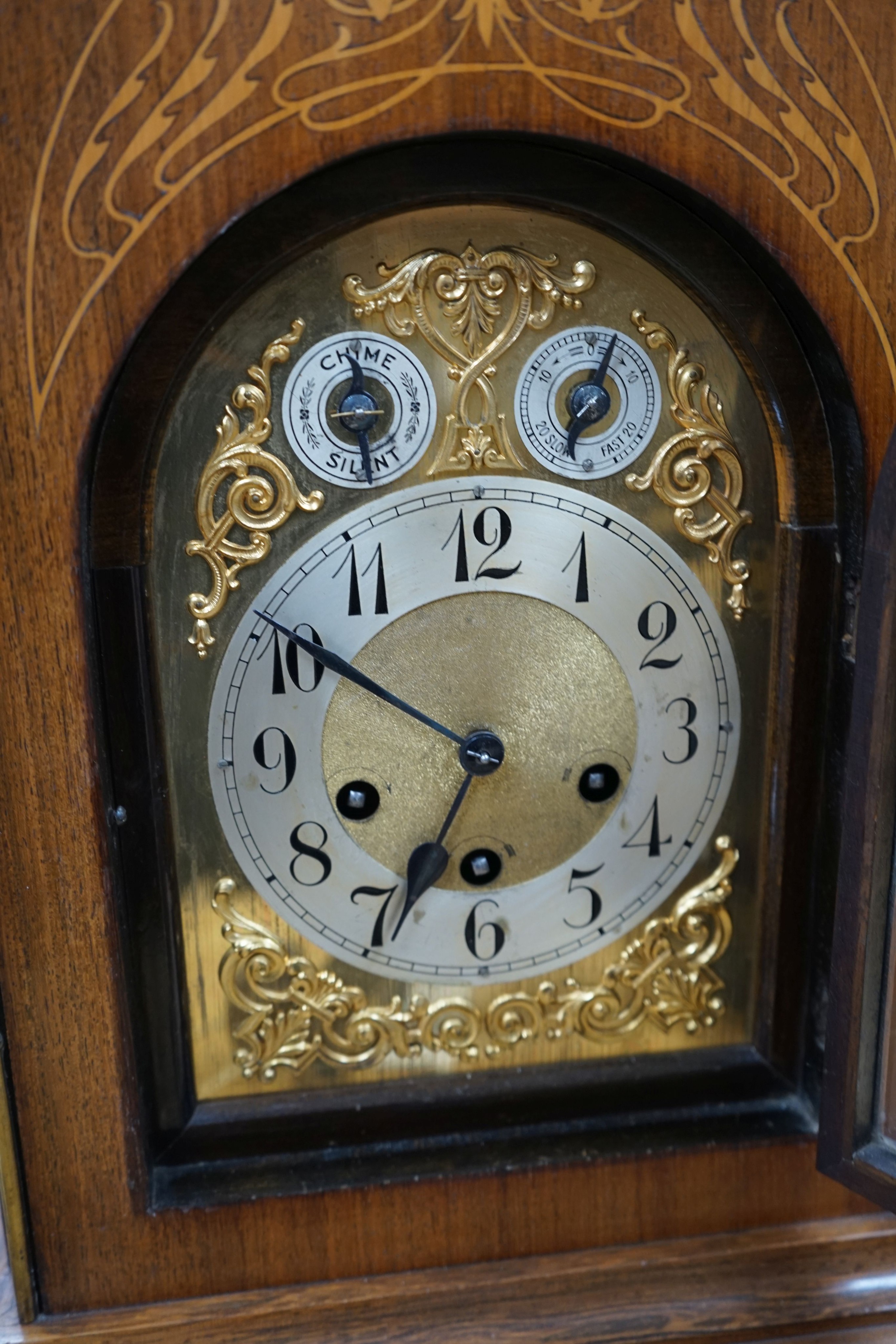 A German rosewood and marquetry chiming mantel clock, early 20th century, 45cm